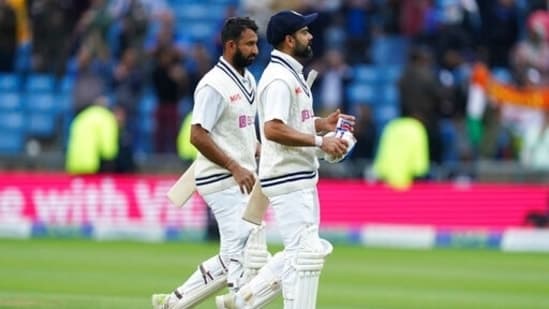 India's captain Virat Kohli, right, and batting partner Cheteshwar Pujara walk off the field at the end of play on the third day of third Test