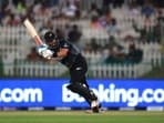 New Zealand's batsman Daryl Mitchell watches his shot during the Cricket Twenty20 World Cup semi-final match between England and New Zealand in Abu Dhabi.