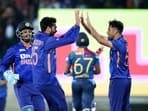 Indian bowler Ravi Bishnoi (R) celebrates with teammate Venkatesh Iyer
