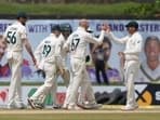 Australia's team members congratulate their bowler Nathan Lyon, second right, for the dismissal of Sri Lanka's Kusal Mendis, right, during the day three of the first test cricket match between Australia and Sri Lanka in Galle.