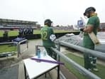Quinton de Kock (centre) and Aiden Markram (right) wait for the game to restart after a rain delay against England in third ODI.