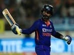 Dinesh Karthik raises his bat after scoring a fifty for India.&nbsp;