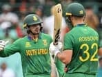 South Africa's Quinton de Kock (L) and Rilee Rossouw celebrate their 150 run partnership during the ICC men's Twenty20 World Cup 2022 cricket match between South Africa and Bangladesh at the Sydney Cricket Ground in Sydney on October 27, 2022. (Photo by Saeed KHAN / AFP) / -- IMAGE RESTRICTED TO EDITORIAL USE - STRICTLY NO COMMERCIAL USE --