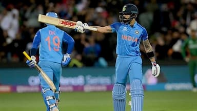 Virat Kohli raises his bat after scoring a half-century during the T20 World Cup match between India and Bangladesh, at Adelaide Oval