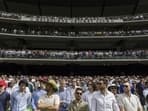 Spectators stand during a tribute to late Australian cricketers Shane
