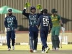 England's captain Jos Buttler, second left, celebrates with bowler Adil Rashid, second right, for dismissing South Africa's batsman Reeza Hendricks, right, for 52 runs during the third One-Day International cricket match between South Africa and England at the Kimberley Oval in Kimberley, South Africa, Wednesday, Feb. 1, 2023. (AP Photo/Themba Hadebe)