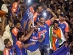 Latest news on July 4, 2024: Players of the T20 World Cup-winning Indian cricket team with the championship trophy acknowledge fans during their open bus victory parade
