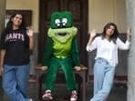 Malhar's mascot Puddles poses with college kids