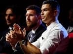 Cristiano Ronaldo and Lionel Messi during a ceremony.