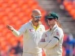 Australia's Nathan Lyon chat with his captain Steve Smith during the third day of the fourth cricket test match between India and Australia in Ahmedabad, India, Saturday, March 11, 2023. (AP Photo/Ajit Solanki)