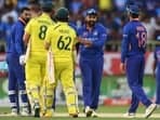 Australia's Mitchell Marsh (2L) and Travis Head (C) greeted by India's captain Rohit Sharma (2R), Virat Kohli (R) and KL Rahul at the end of the second one-day international (ODI) cricket match between India and Australia at the Y.S. Rajasekhara Reddy Cricket Stadium in Visakhapatnam on March 19, 2023. (Photo by Noah SEELAM / AFP) / GETTYOUT / IMAGE RESTRICTED TO EDITORIAL USE - STRICTLY NO COMMERCIAL USE