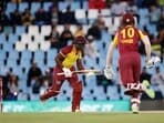 West Indies' Rovman Powell (L) and Roston Chase run between the wickets during the first T20I against South Africa