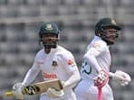 Bangladesh's Mushfiqur Rahim (R) and Mominul Haque run between the wickets during the fourth day of the Test cricket match between Bangladesh and Ireland at the Sher-e-Bangla National Cricket Stadium in Dhaka on April 7, 2023. (Photo by Munir uz ZAMAN / AFP)