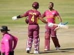 West Indies batsman Nicholas Pooran and Shai Hope celebrate after they both scored 100 runs during their ICC Men's Cricket World Cup Qualifier match against Nepal at Harare Sports Club in Harare, Zimbabwe, Thursday June, 22, 2023. AP/PTI(AP06_22_2023_000210B)