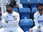 India's captain Rohit Sharma (L) looks on during a break in play 