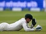 Australia's wicket keeper Alex Carey reacts after failing to take a catch