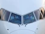 Pilots are seen in the cockpit of an airplane as it sits on the tarmac at John F. Kennedy International Airport on the July 4th weekend in Queens, New York City, U.S., July 2, 2022. REUTERS/Andrew Kelly