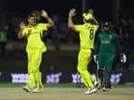 Aaron Hardie celebrates with Mitchell Marsh after taking a wicket