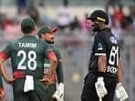 New Zealand's Ish Sodhi (R) speaks with Bangladesh's players during the second one-day international 