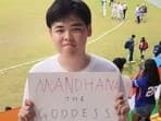 Wei Junyu holds 'Mandhana The Goddess' placard during Asian Games women's cricket final