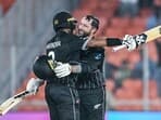 New Zealand's Devon Conway (R) celebrates with Rachin Ravindra after scoring a century (100 runs) during the 2023 ICC men's cricket World Cup