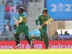 South Africa's skipper Temba Bavuma and Quinton de Kock run between the wickets during the ICC Men's Cricket World Cup 2023 match against Australia.