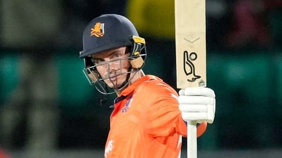 Netherlands skipper Scott Edwards raises his bat as he celebrates his half-century during their match against South Africa