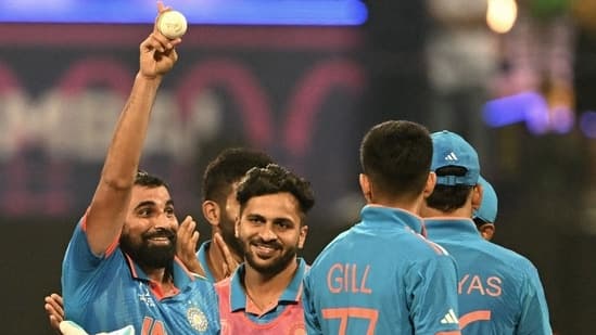 Mohammed Shami celebrates with teammates after taking five wickets during the 2023 ICC Men's Cricket World Cup match between India and Sri Lanka