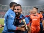Afghanistan's skipper Hashmatullah Shahidi being congratulated by team members and staff after winning the match against Netherlands in the ICC Men's Cricket World Cup 2023,