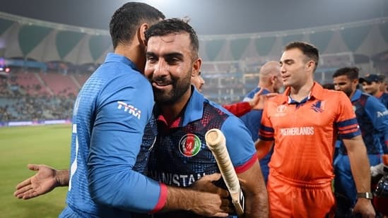 Afghanistan's skipper Hashmatullah Shahidi being congratulated by team members and staff after winning the match against Netherlands in the ICC Men's Cricket World Cup 2023,