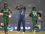 Bangladesh's Mahmudullah (L) and Mushfiqur Rahim run between the wickets as Sri Lanka's Angelo Mathews (C) watches during the 2023 ICC Men's Cricket World Cup one-day international (ODI) match 