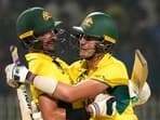 Australia's captain Pat Cummins and Mitchell Starc celebrate after winning the ICC Men's Cricket World Cup 2023 second semi-final match against South Africa.