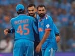 India's captain Rohit Sharma, Virat Kohli, Mohammed Shami and Jasprit Bumrah celebrate after winning the ICC Men's Cricket World Cup 2023 first semi-final match against New Zealand, at the Wankhede Stadium