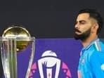 India's Virat Kohli walks past ICC Men's Cricket World Cup trophy to receive player of the tournament award 