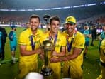 Australian captain Pat Cummins, Josh Hazlewood and Mitchell Starc pose for photographs with the World Cup trophy