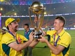 Australian players Travis Head and Marnus Labuschagne pose for photographs with the trophy as they celebrate after winning the ICC Men's Cricket World Cup 2023 finals at the Narendra Modi Stadium, in Ahmedabad.