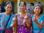 Voters show their fingers marked with indelible ink after casting their votes for Mizoram Assembly elections, in Mamit district