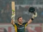 Josh Inglis celebrates after scoring a century during the first T20 cricket match between India and Australia.