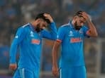 India's Virat Kohli, left, and Mohammed Siraj react after losing the ICC Men's Cricket World Cup final match against Australia.