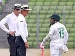 Bangladesh's Mushfiqur Rahim talks to umpires after he was declared out for obstructing the filed