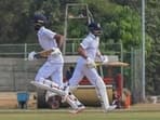 Devdutt Padikkal and Manish Pandey run between the wickets during the second day of the Ranji Trophy cricket match between Karnataka and Punjab.
