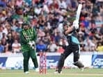 New Zealand's Finn Allen plays a shot while being watched by Pakistan's wicketkeeper Azam Khan (L)