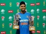 India's Suryakumar Yadav holds the player of the match and player of the series trophies 