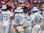 India's captain Rohit Sharma (2R) speaks with his teammates