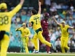 Australia's Sean Abbott, center, celebrates taking the wicket of West Indies' Kjorn Ottley, second right.