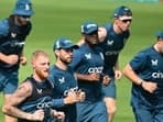 England's captain Ben Stokes (2L) warms up with teammates during a practice session 