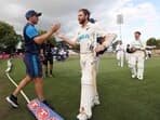 New Zealand's Kane Williamson (R) is congratulated by captain Tim Southee (L) after their team's victory