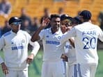 India's Ravichandran Ashwin (2L) celebrates with teammates after taking the wicket of England's captain Ben Stokes during the third day of the fifth and last Test cricket match between India and England at the Himachal Pradesh Cricket Association Stadium in Dharamsala on March 9