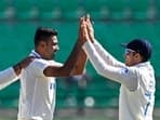 India's Ravichandran Ashwin (C) celebrates with Shubman Gill (R) during the Test series against England