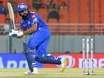 Mumbai Indians' Rohit Sharma watches the ball after playing a shot.